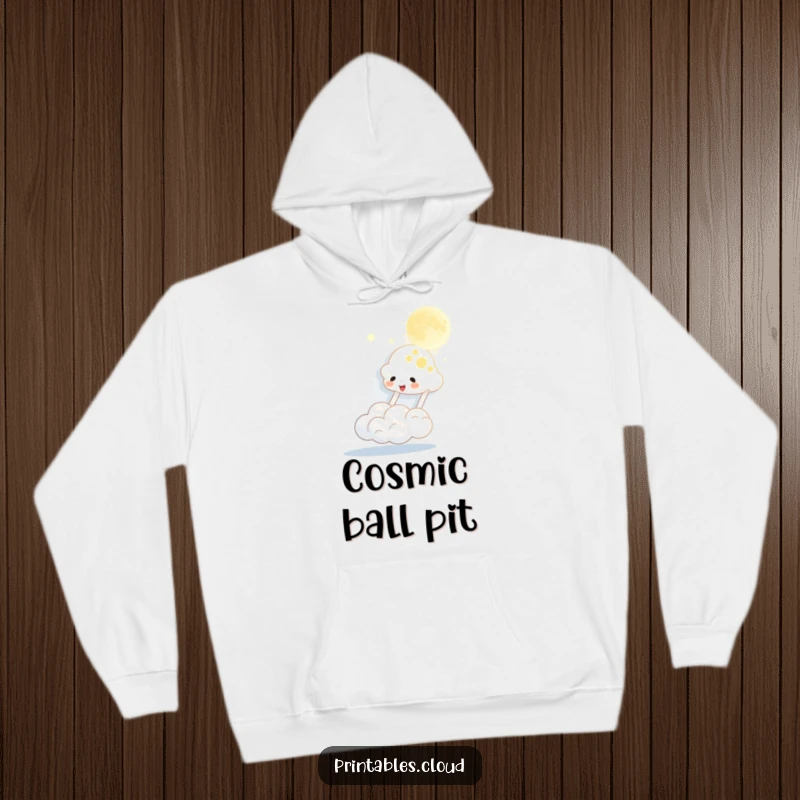 Funny hoodie depicting a cheerful cloud character bouncing the moon like a playful ball, offering warm comfort and a hearty chuckle.