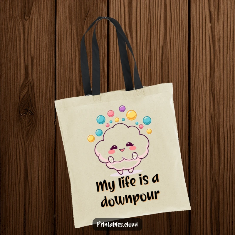 Funny tote bag with a delighted fluffy cloud character juggling colorful raindrops, perfect for carrying essentials with cheer.